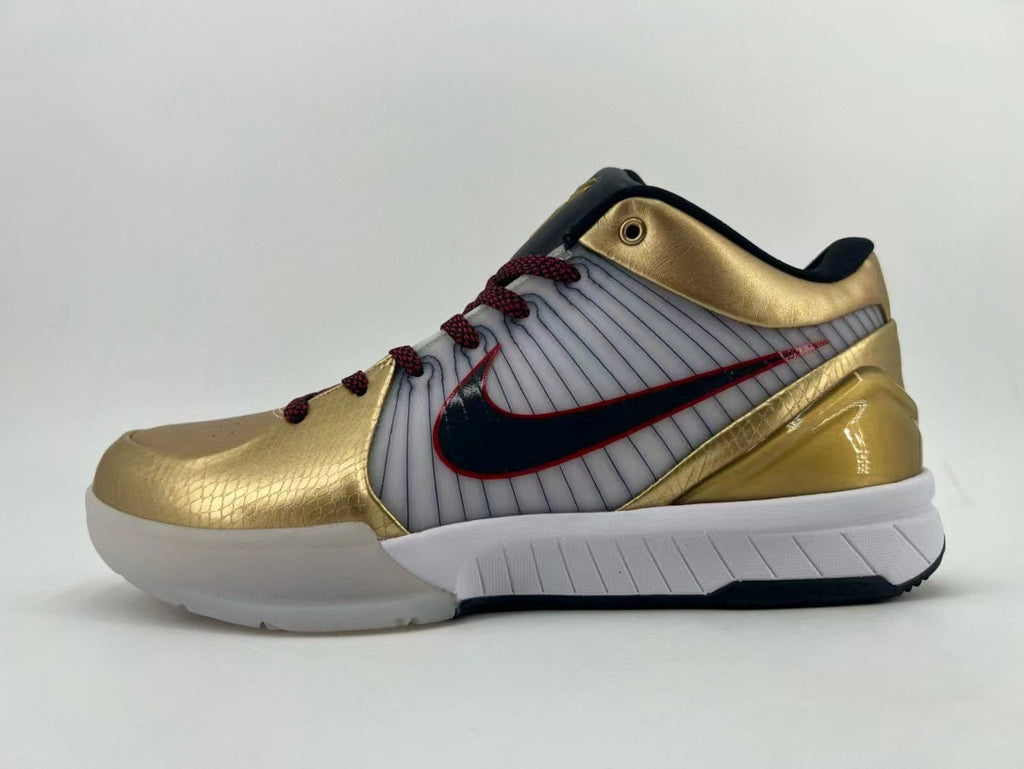 Side profile of the gold, white, and black sneaker with red accents.