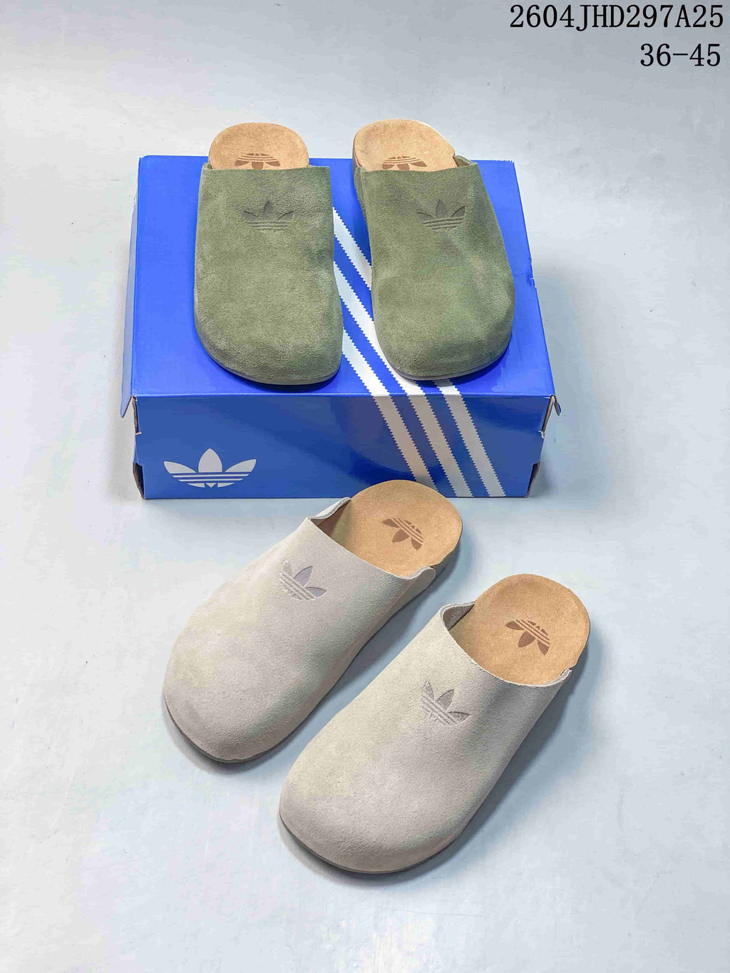 Green and light beige Adimule slides shown together from above, with Adidas branding visible on the uppers and footbeds.