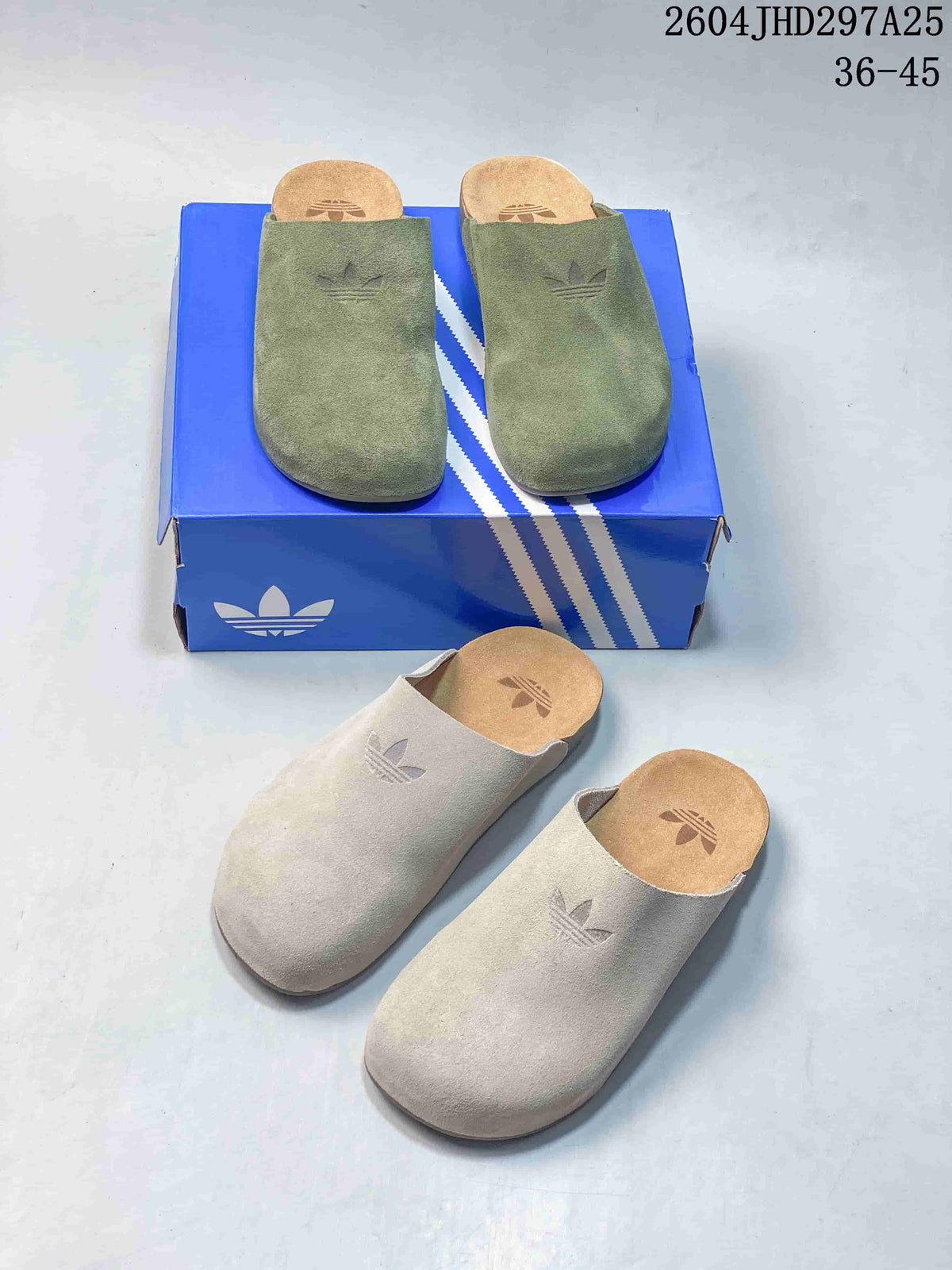Green and light beige Adimule slides shown together from above, with Adidas branding visible on the uppers and footbeds.