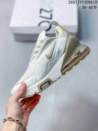 Side view of a white and light cream Nike Air Max 270 sneaker showing the side Swoosh, Air Max marking, and heel air unit.
