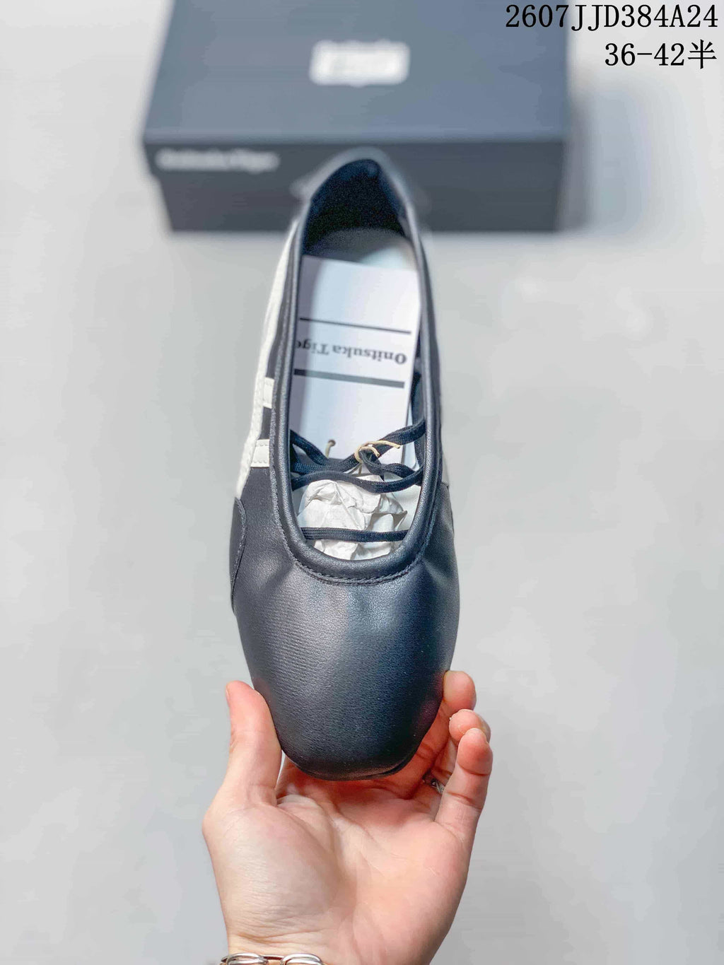 Top view showing the rounded toe, strap detailing, dark navy upper, and interior branding.