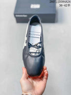 Top view showing the rounded toe, strap detailing, dark navy upper, and interior branding.
