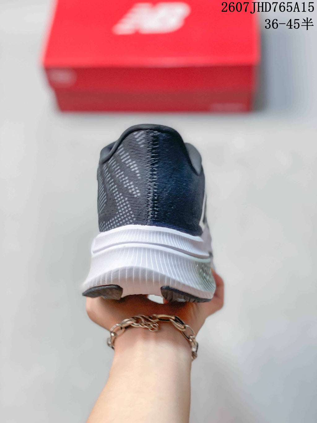 Rear view of the dark gray running shoe showing the heel counter and white midsole.
