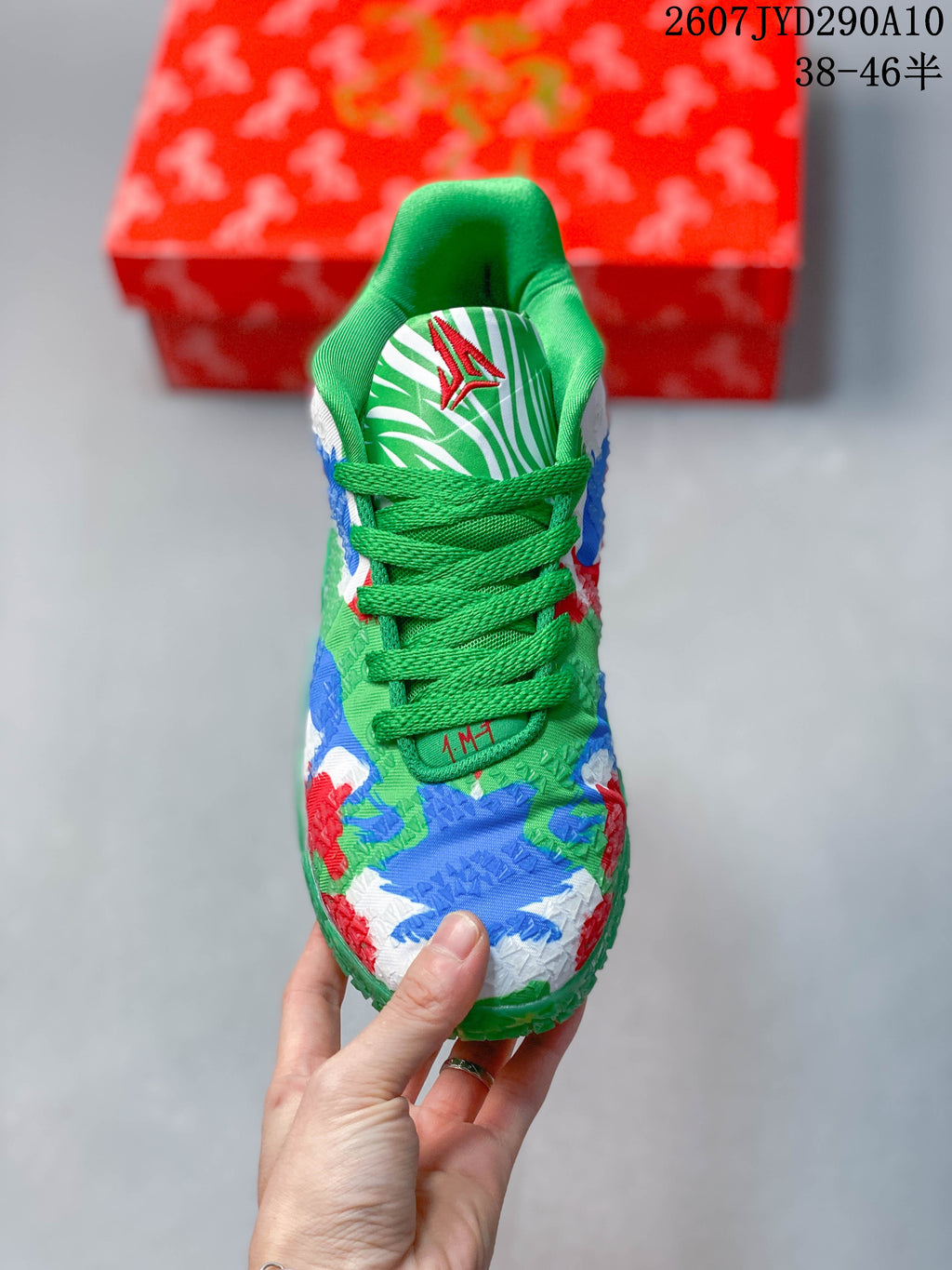Top view of the Nike Ja 3 sneaker showing green laces, patterned tongue, and multicolor upper.