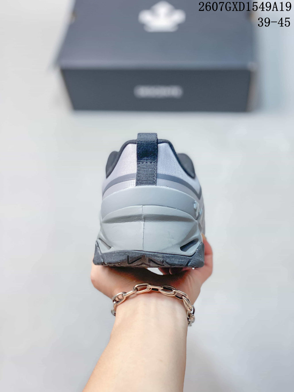 Rear view of the gray sneaker showing the padded heel collar and pull tab.