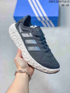 Side profile of the dark sneaker with three-stripe detailing and a contrasting white textured sole.