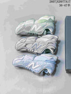 Three views of the light-colored New Balance sneakers arranged to show the side profiles, layered panels and thick soles.