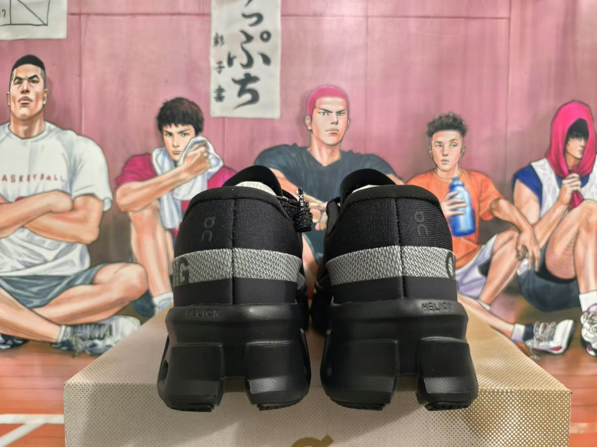 Rear view of black On Running sneakers showing dark gray heel bands and chunky soles.