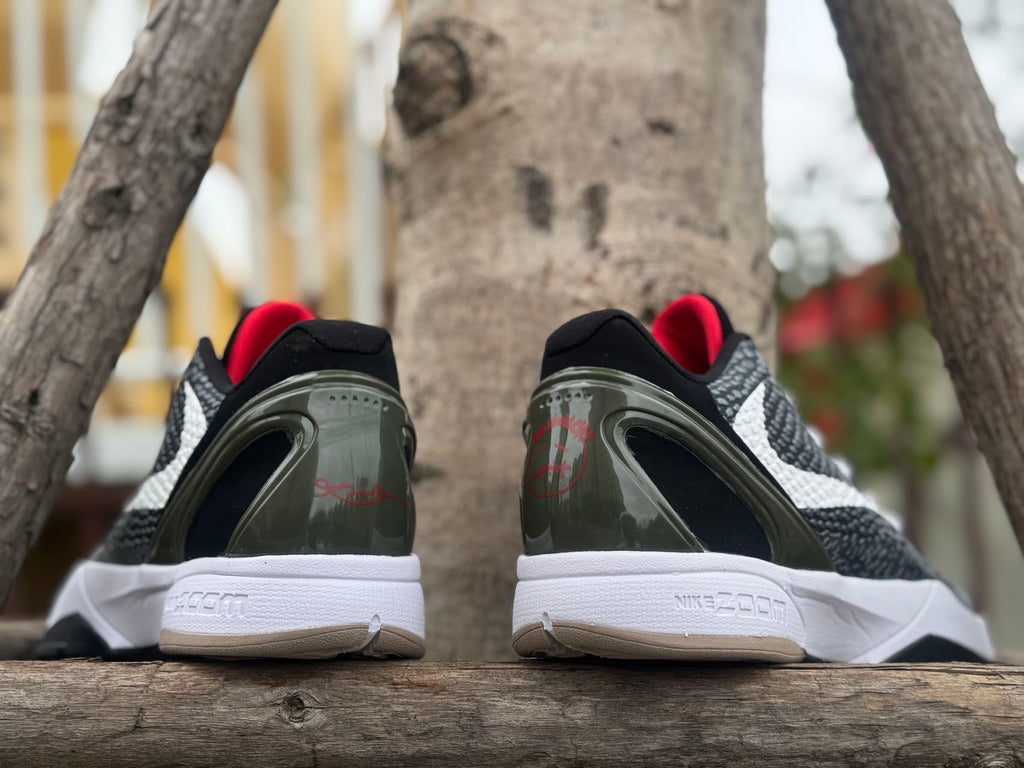 Rear view of the pair with dark heel details and red accents