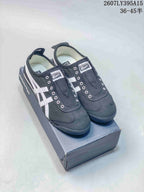 Black Onitsuka Tiger sneakers with white side stripes displayed on a branded shoe box; style code 2607LY395A15 and size range 36–45 are overlaid.