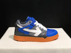 Opposite side profile showing the low-top silhouette, blue and grey upper, white laces, arrow detail, and textured outsole.