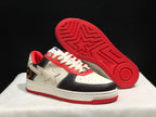 Angled view with one sneaker lifted to show the red outsole pattern and star-shaped tread detail.