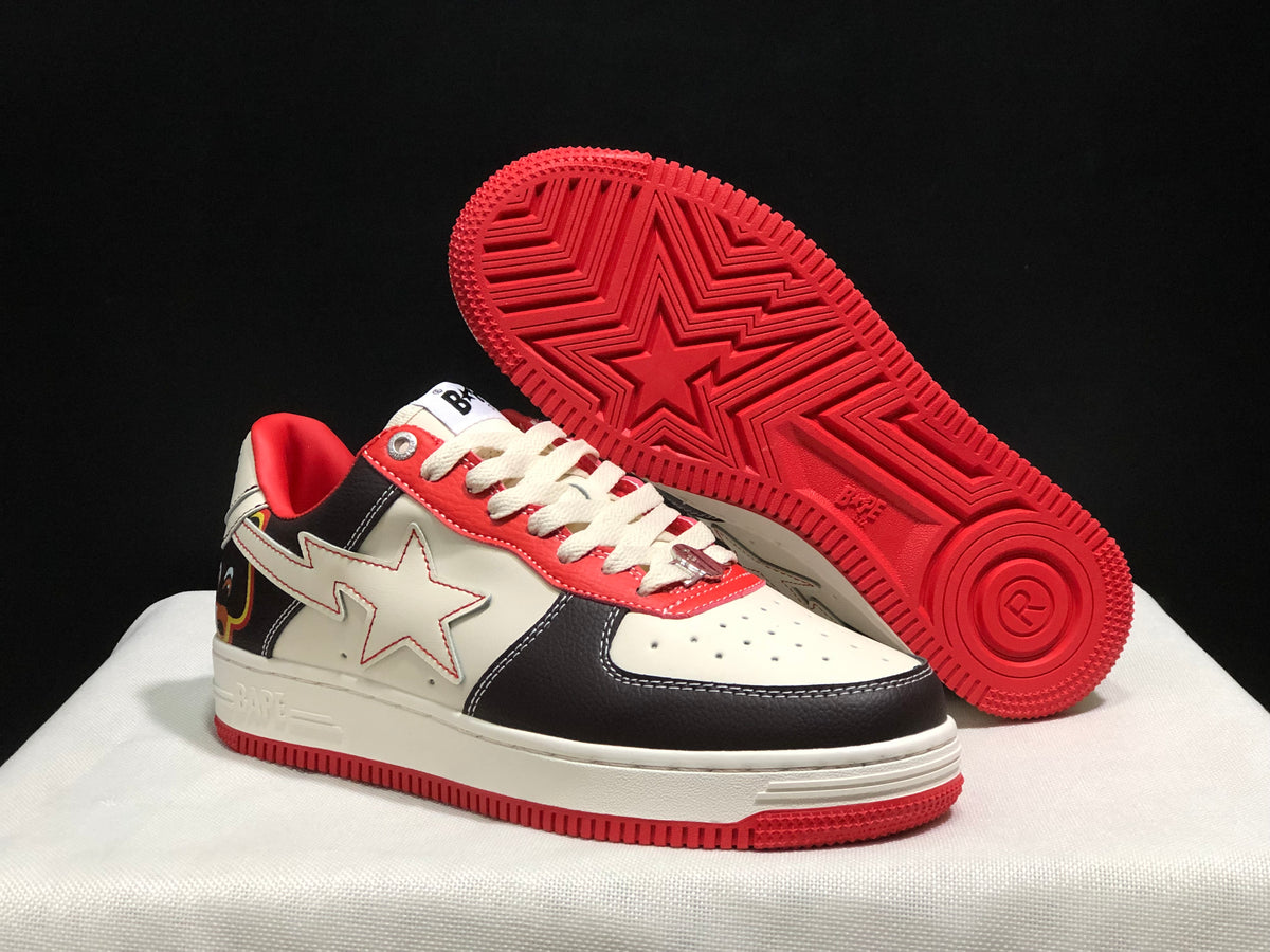 Angled view with one sneaker lifted to show the red outsole pattern and star-shaped tread detail.