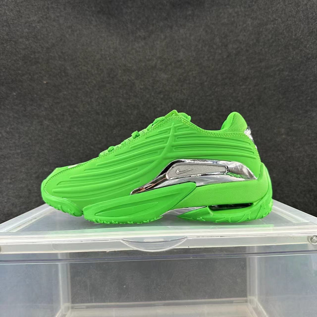 Bright green low-top sneaker with sculpted side panels and silver-look side accent