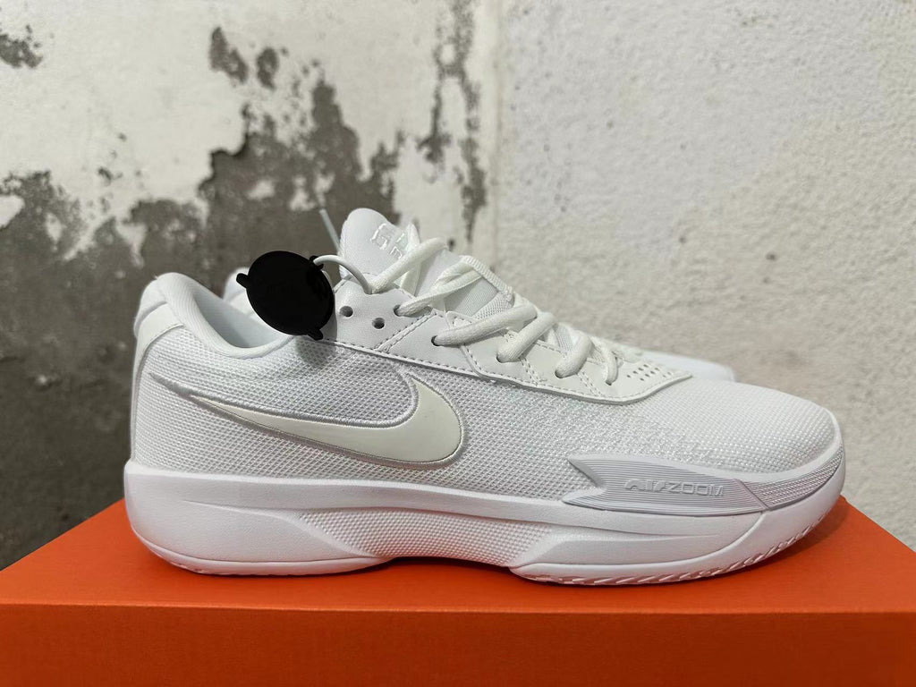 Side view of a white Nike G.T. Cut Academy shoe with Nike Swoosh and model lettering