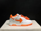 Side profile close-up highlighting the orange side arrow, white panels, orange collar trim, and outsole.
