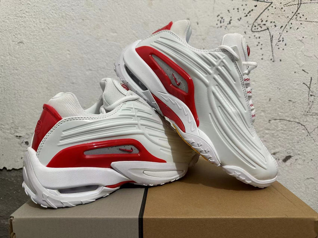 Pair of white sneakers with red side accents, shown from multiple angles