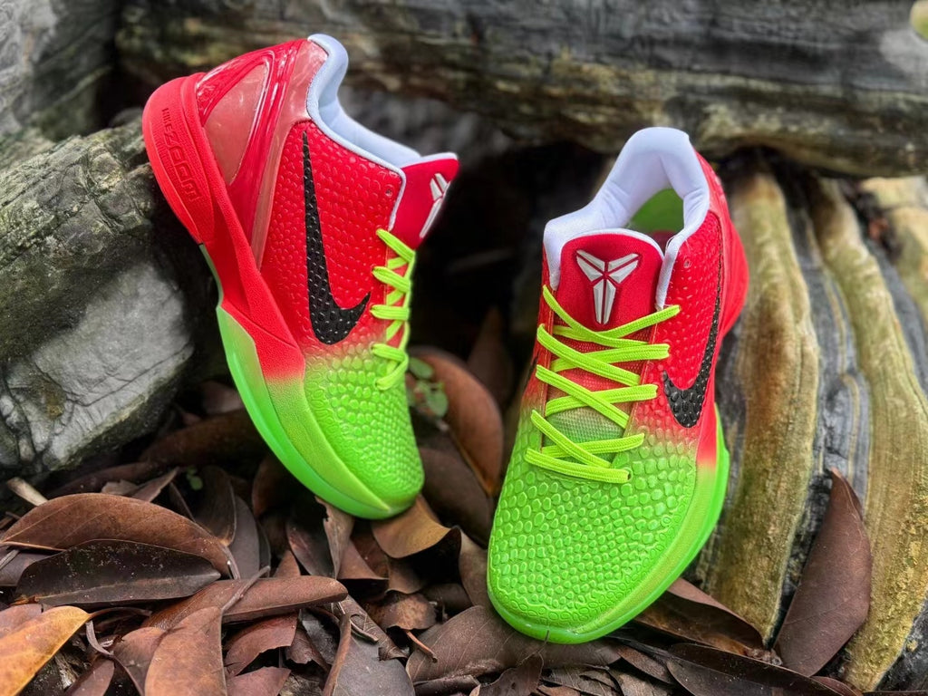 Pair of red and bright green Nike Kobe 6 shoes with black side Swooshes and neon green laces