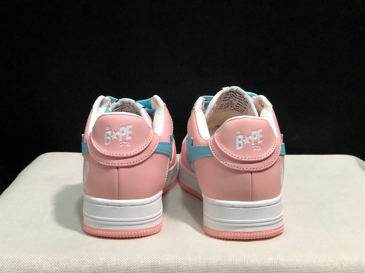Rear view of the pair showing pink heel panels, padded white collars, and Bape Sta branding.
