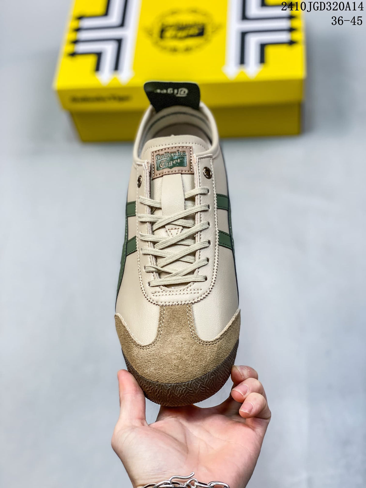 Top view of the lace-up sneaker showing the cream upper, brown toe overlay, green side accents and branded tongue label.