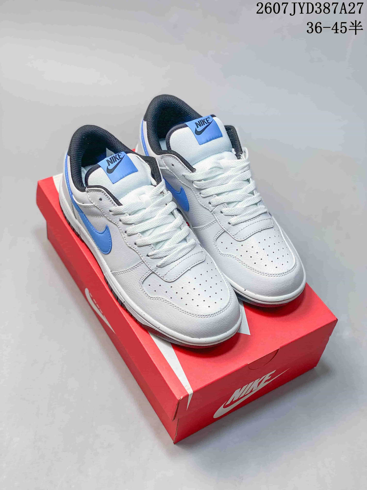 Pair of white and blue Nike low-top sneakers displayed on a red shoebox.