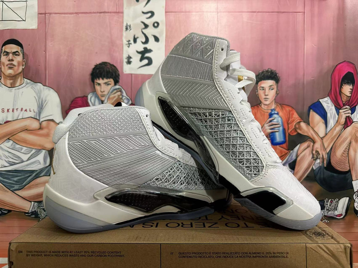 Pair of white and metallic silver Jordan basketball shoes shown from the sides