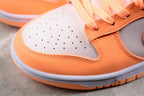 Close-up of the perforated light gray toe panel, orange overlay, stitching, and layered sole.