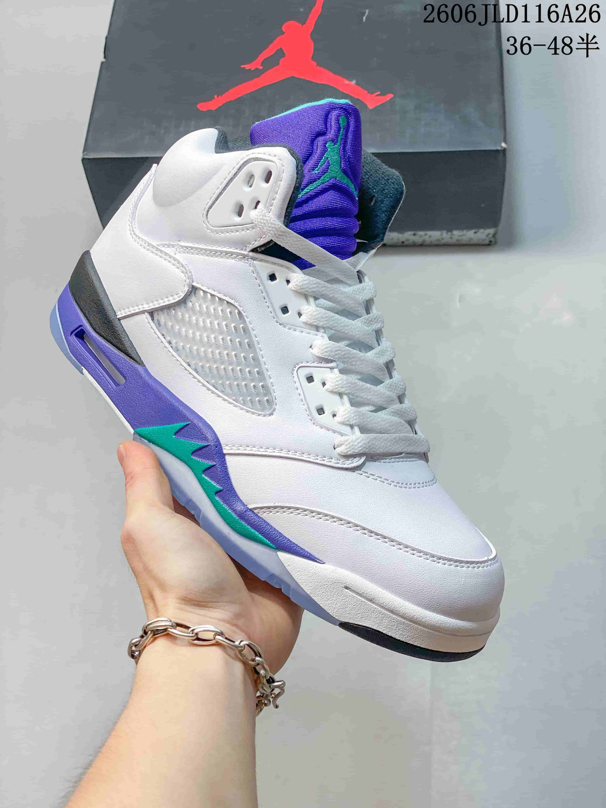 Side view of a white Air Jordan 5 high-top sneaker with purple and teal accents
