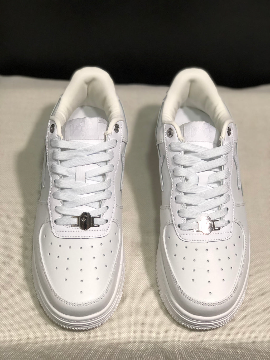 Overhead front view showing the lace arrangement, metal lace details, and perforated toe boxes.