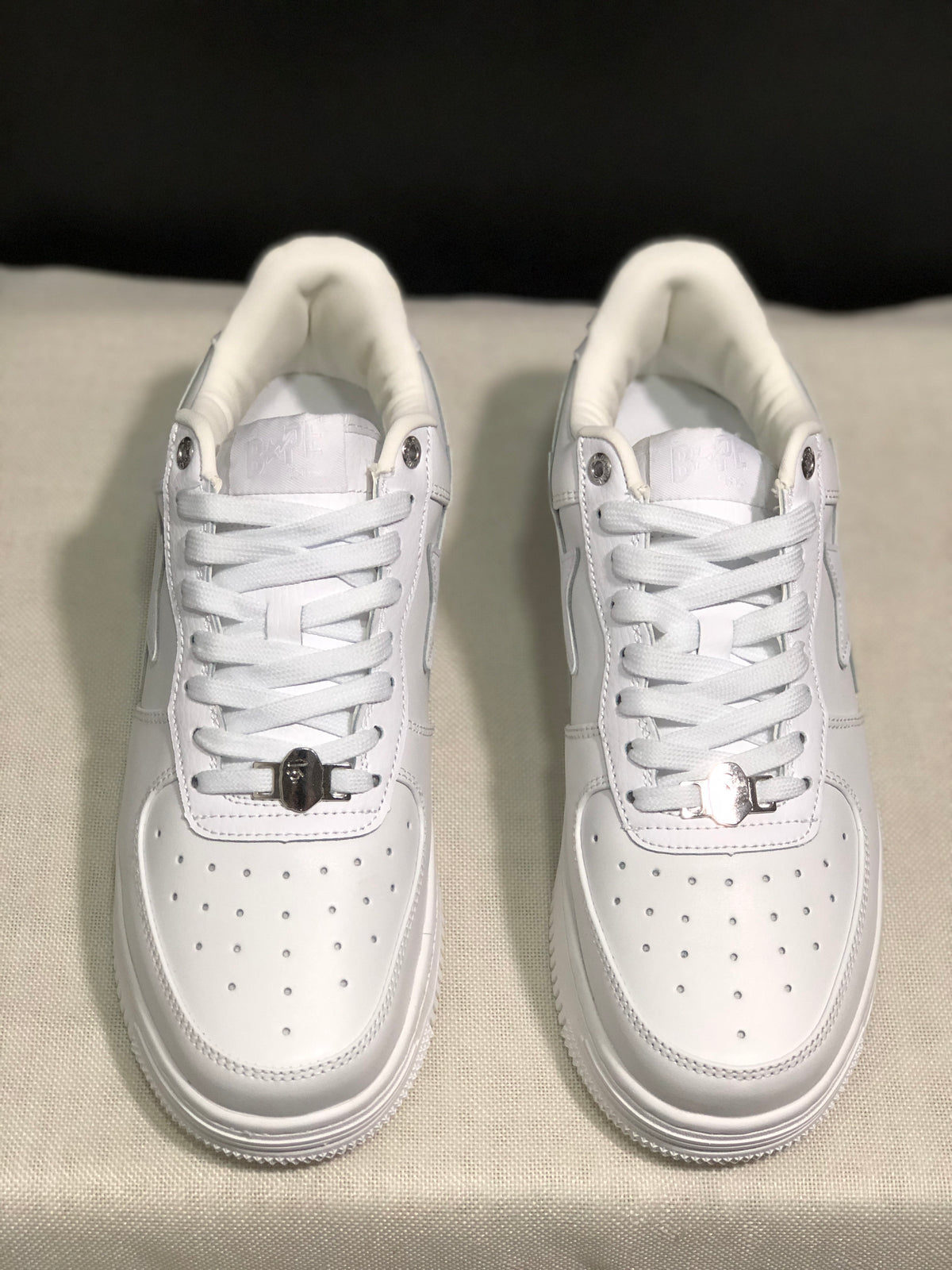 Overhead front view showing the lace arrangement, metal lace details, and perforated toe boxes.