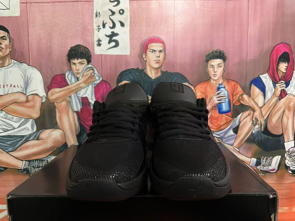 Front view of black lace-up basketball shoes with Swoosh tongue labels