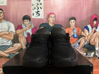 Front view of black lace-up basketball shoes with Swoosh tongue labels