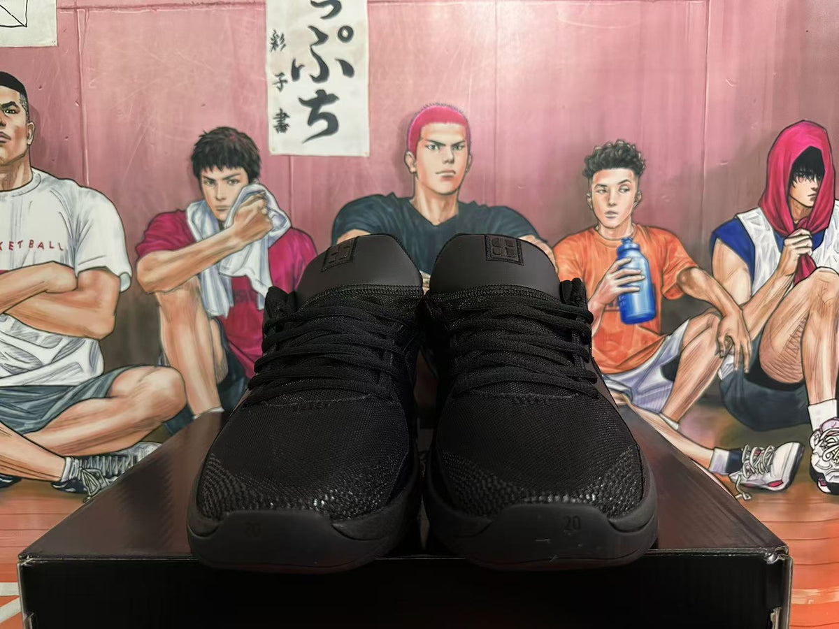 Front view of black lace-up basketball shoes with Swoosh tongue labels