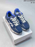 Pair of navy Premiata Lander trainers with white laces and bright blue collar accents displayed on a shoebox.