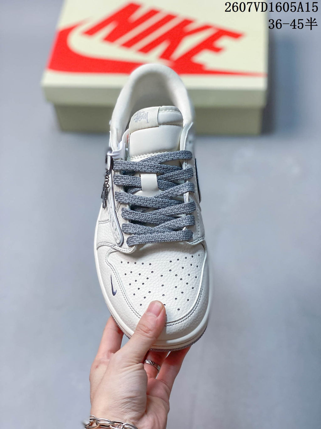 Top view showing the perforated white toe box, gray laces, padded tongue, and low-top construction.