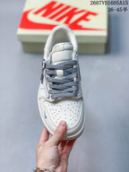 Top view showing the perforated white toe box, gray laces, padded tongue, and low-top construction.