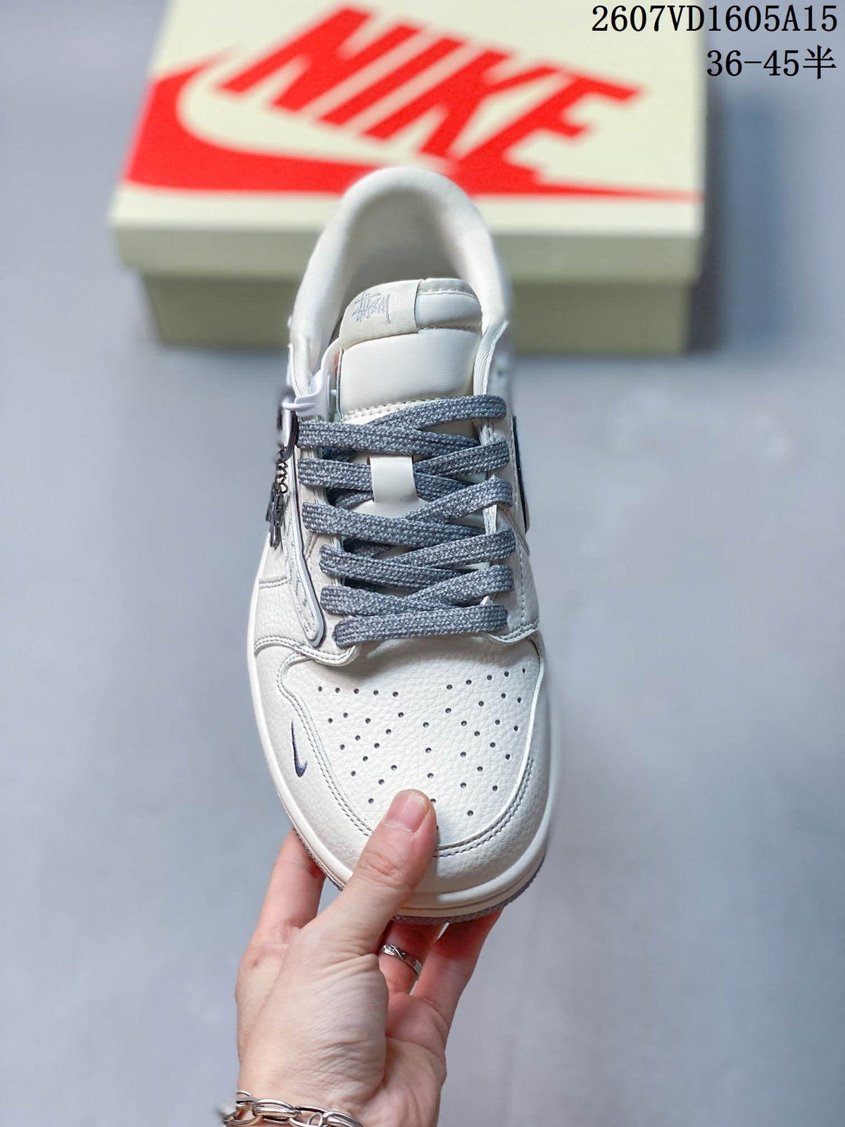 Top view showing the perforated white toe box, gray laces, padded tongue, and low-top construction.