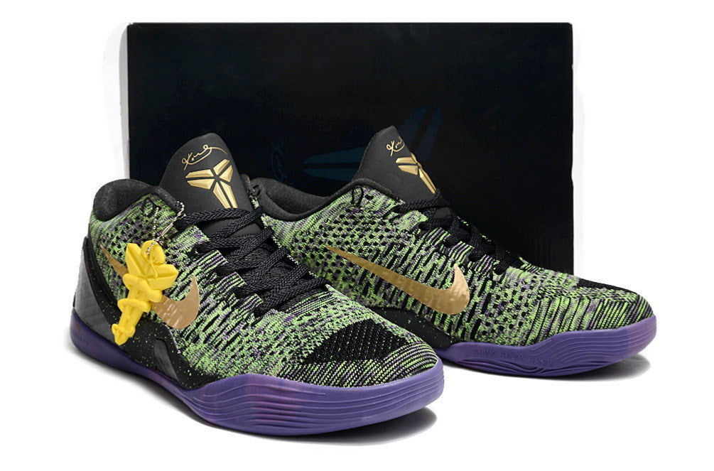 Pair of black, green, and purple basketball shoes with a dark box behind them.