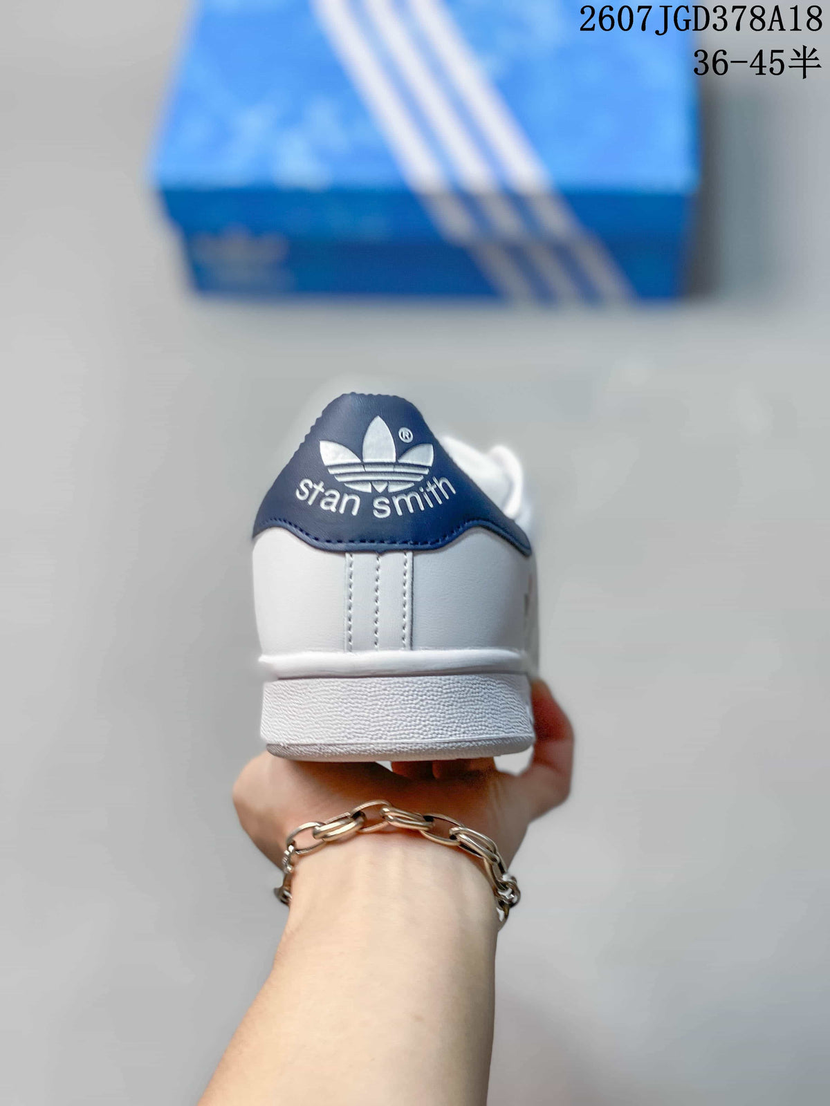 Rear view showing the navy heel tab with trefoil branding and Stan Smith text.