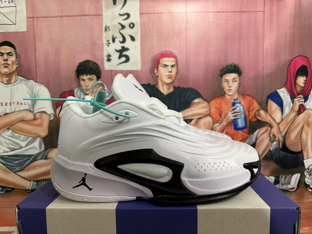 Side view of a white Jordan basketball sneaker with black detailing and a sculpted sole