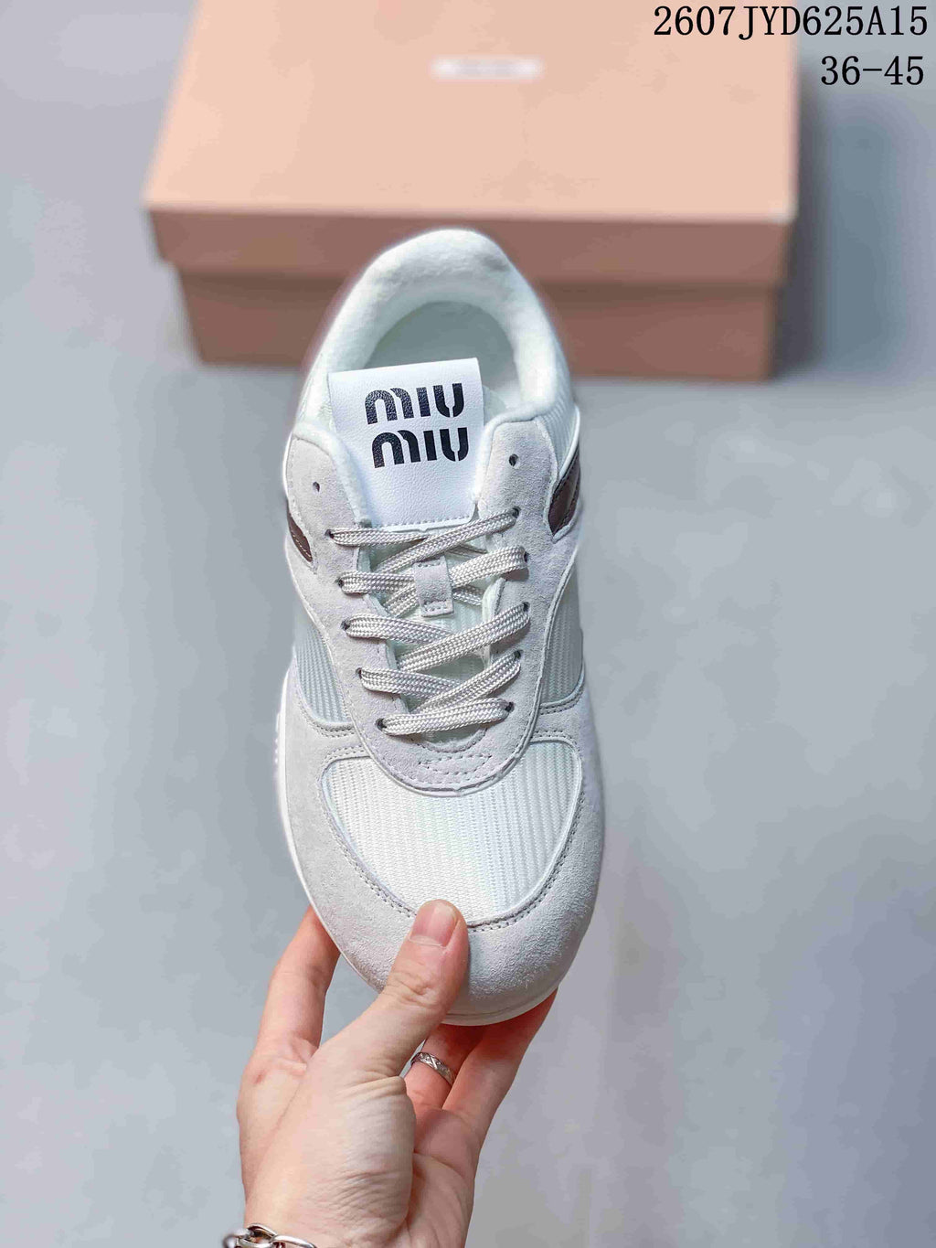 Top view of the sneaker showing tonal laces, white panels, burgundy side detailing, and Miu Miu branding on the tongue.