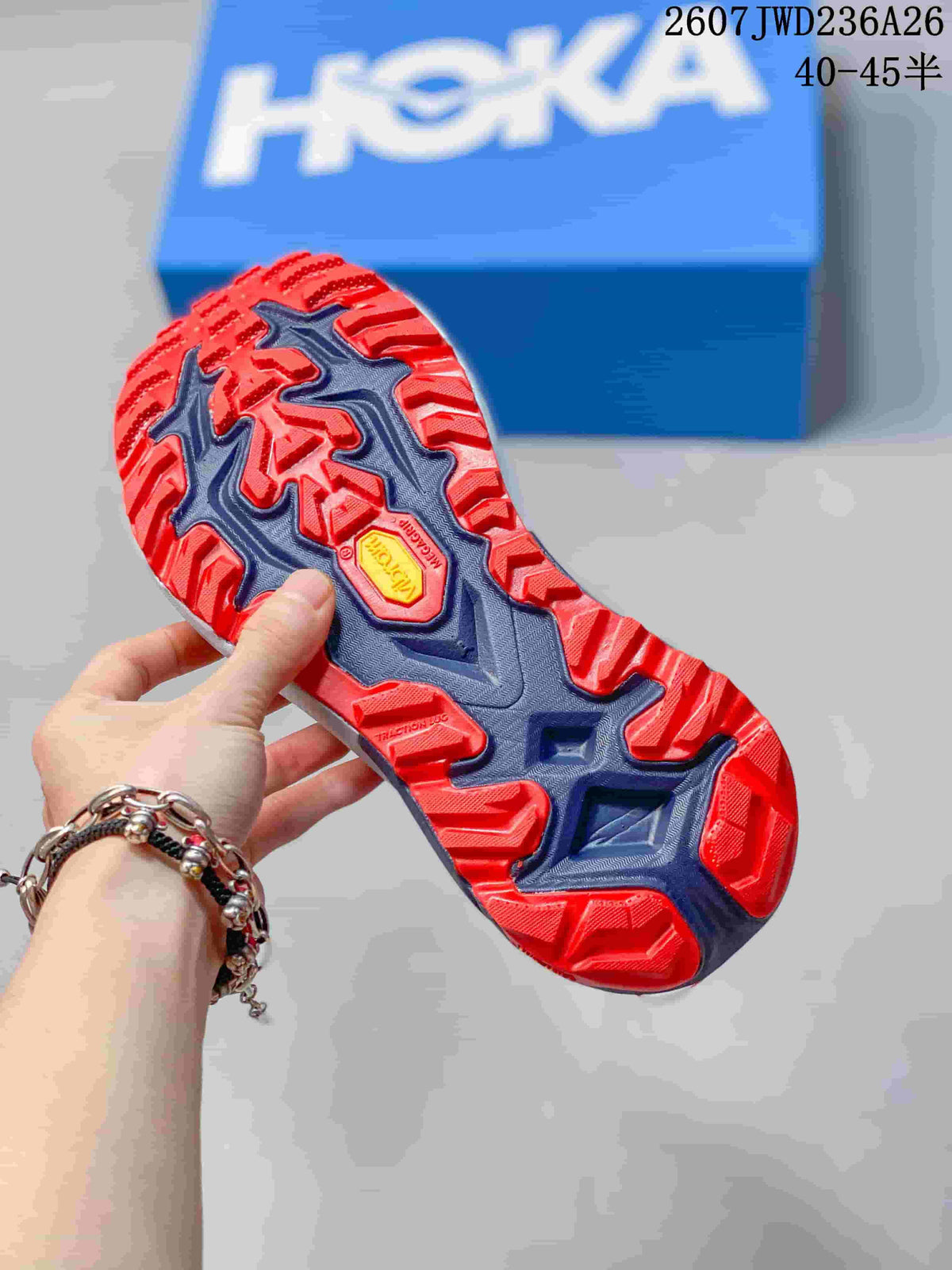 Underside view showing the navy and red outsole with pronounced traction lugs.