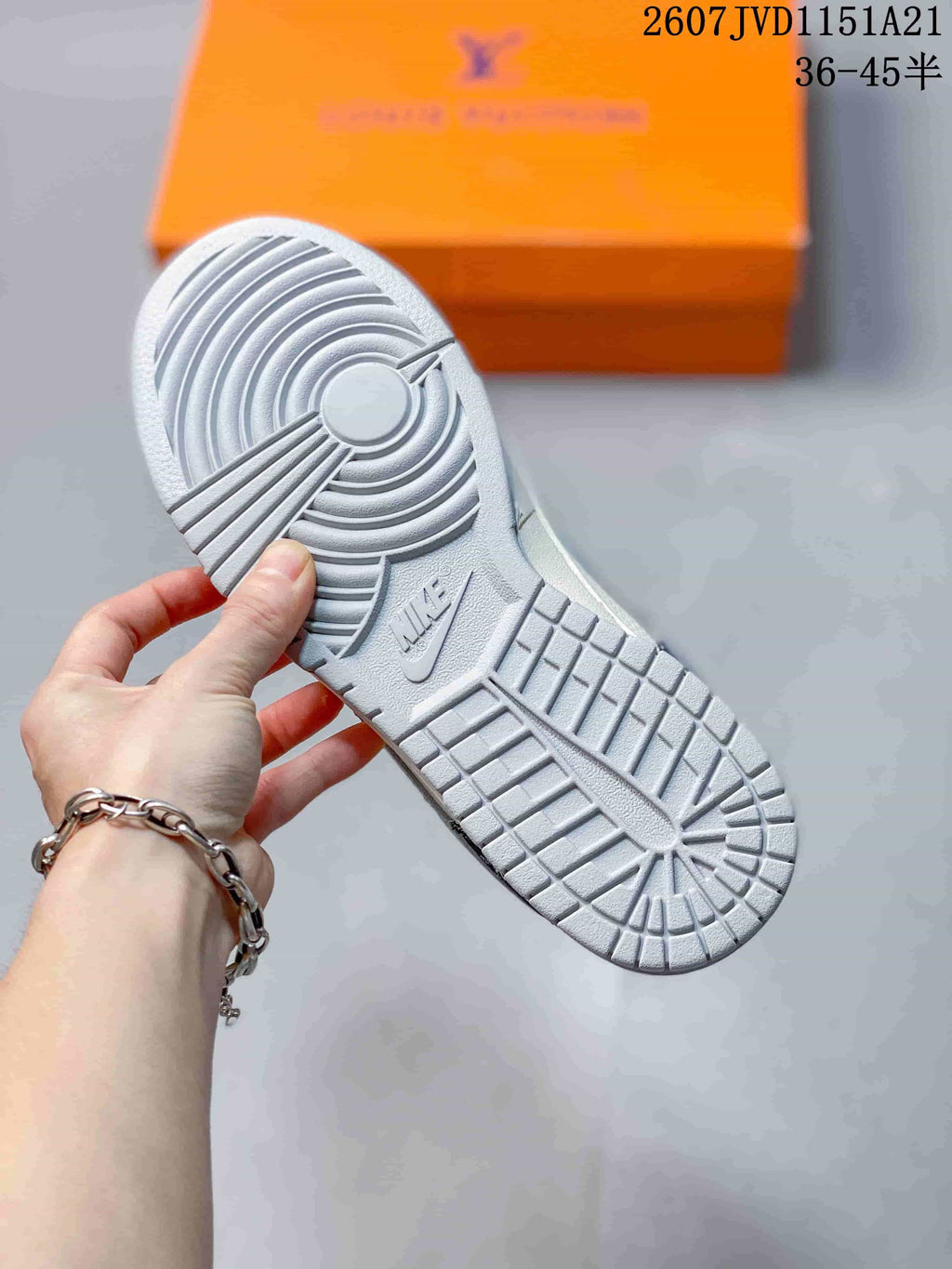 Close view of the sneaker's grey rubber outsole with circular traction patterns.