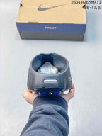Rear view of the closed-toe slide showing the heel opening, side detailing, and presentation box.