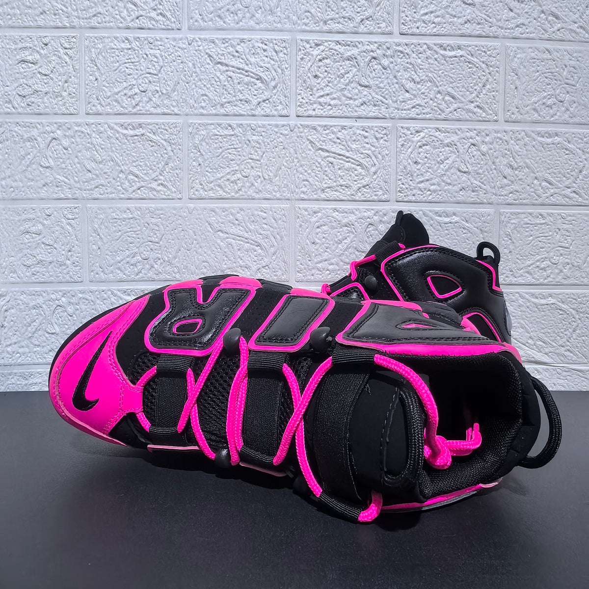 Top view showing pink laces and black uppers