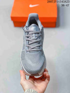 Front view of the grey Nike Vomero Premium sneaker showing the lace-up closure, tongue branding and rounded toe.