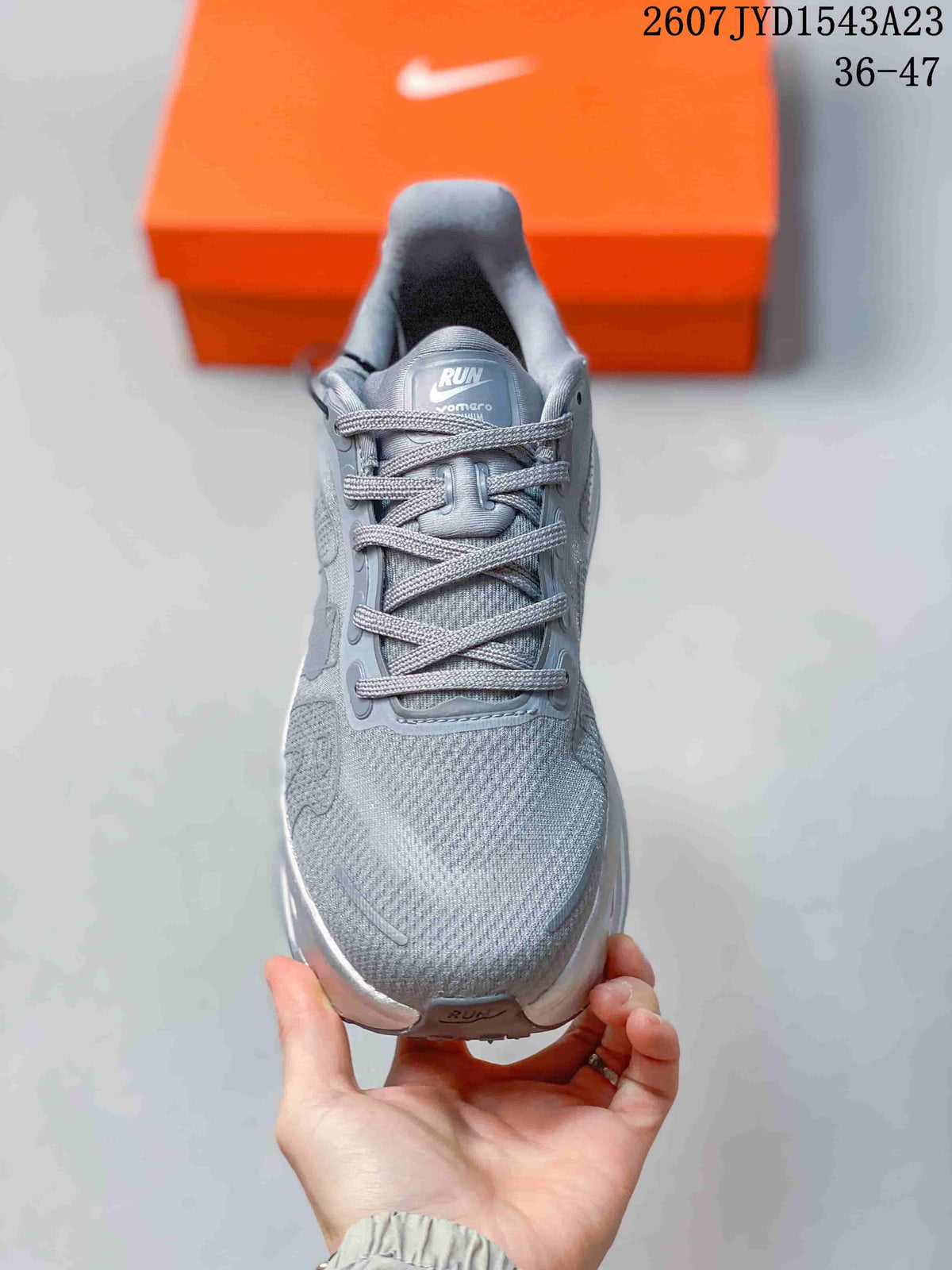 Front view of the grey Nike Vomero Premium sneaker showing the lace-up closure, tongue branding and rounded toe.