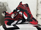 Pair of black-and-red Jordan Tatum 1 basketball shoes shown from the side