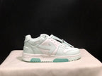 Side profile of the white sneaker showing the low-top shape, layered panels, heel detailing and pale mint outsole accents.