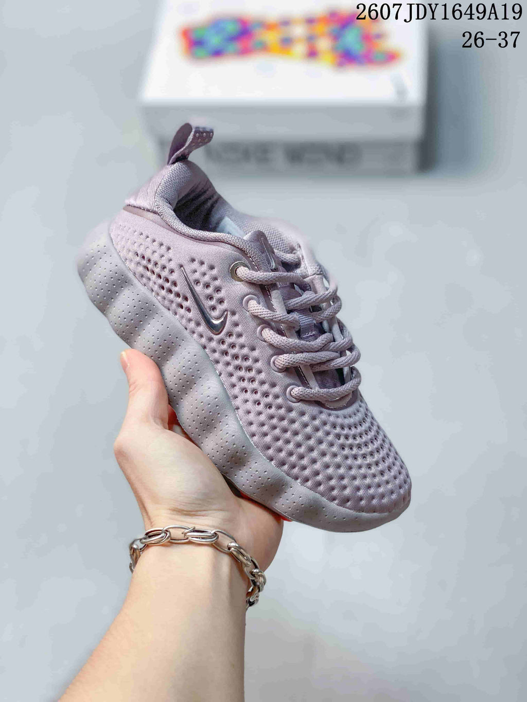 Gray Nike Mind 002 kids sneaker with perforated upper, lace-up closure and segmented sole.